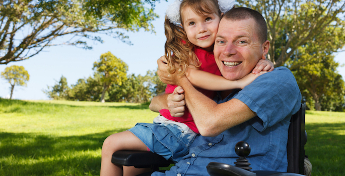 disabled man plays with his daughter
