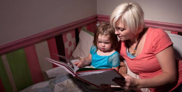 caucasian mom reading bedtime story mom reading bedtime story to toddler girl