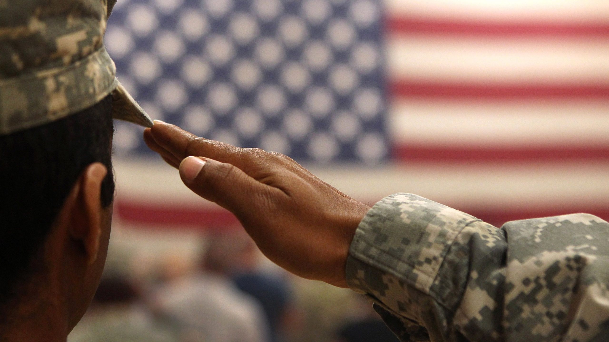 A soldier salutes the U.S. flag