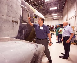 Person striking helicopter with sledgehammer