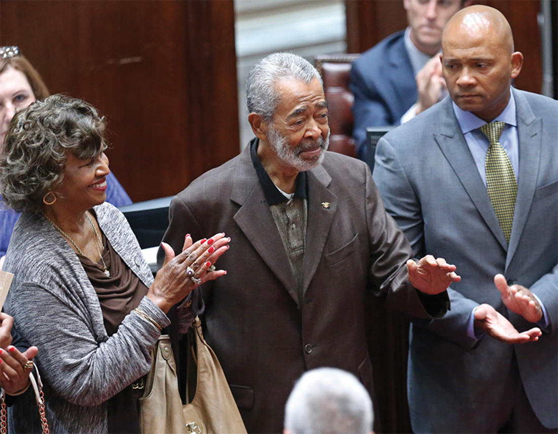 Porter, center, is honored on the floor of the Oklahoma Senate in May 2015. At left is his former wife, Leona Porter, and at right is his son E. Dion Porter. (SUE OGROCKI/AP)