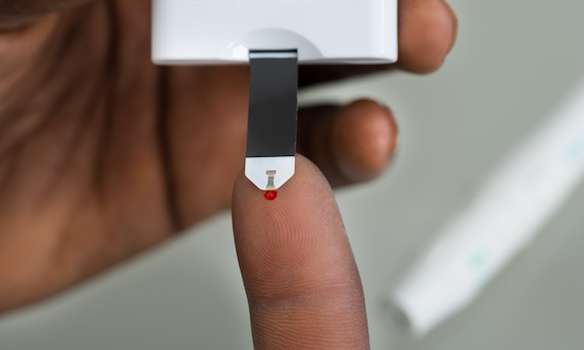 Close-up Of Patient Hands Measuring Glucose Level Blood Test With Glucometer