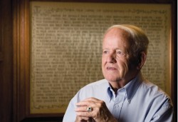 Robert Vantrease in front of the Hippocratic Oath he hand lettered. (photo by Joe Howell/Vanderbilt)