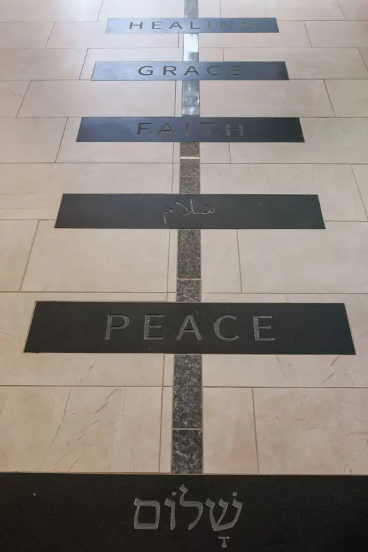 A blue granite pathway is intersected by 12 black granite tiles engraved with words that exemplify the Divinity School’s mission. (Anne Rayner/Vanderbilt)
