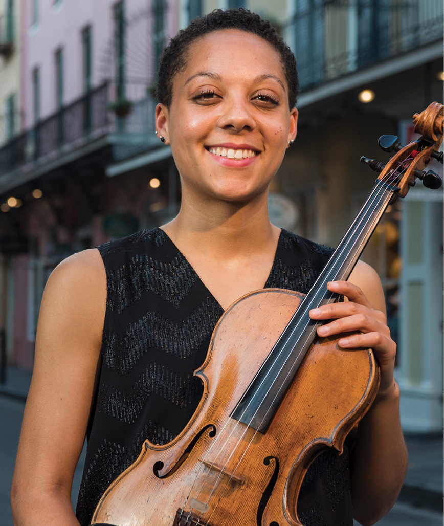Portrait of Dana Kelley with her viola on an urban street