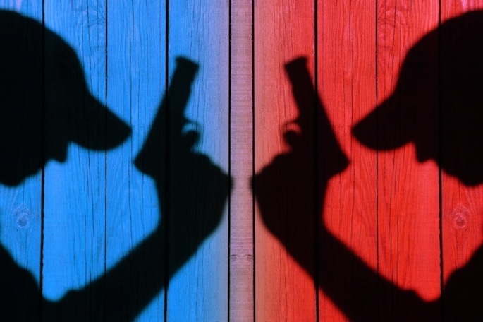 silhouette of armed men