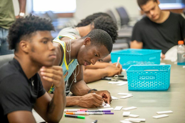 Student-athletes are encouraged to use their creative skills while decorating "tiles" provided by the Wond'ry for a collaborative art workshop. (John Russell/Vanderbilt)