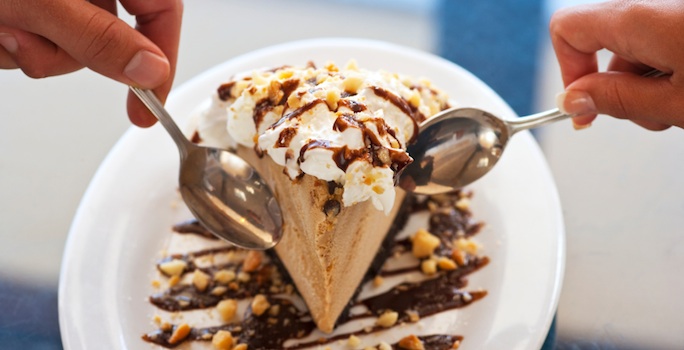 two spoons dipping into a creamy chocolate pie