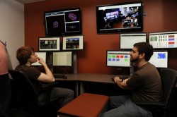 Researchers sitting at computers looking at monitors