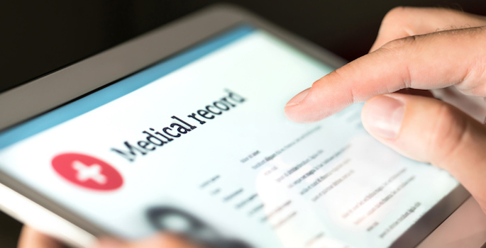 Electronic medical record on tablet in a person's hand
