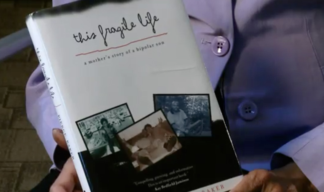 Charlotte Pierce-Baker holds her book 