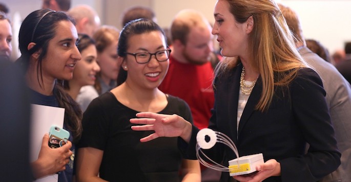 students discussing device