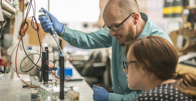 Merryman in lab with student