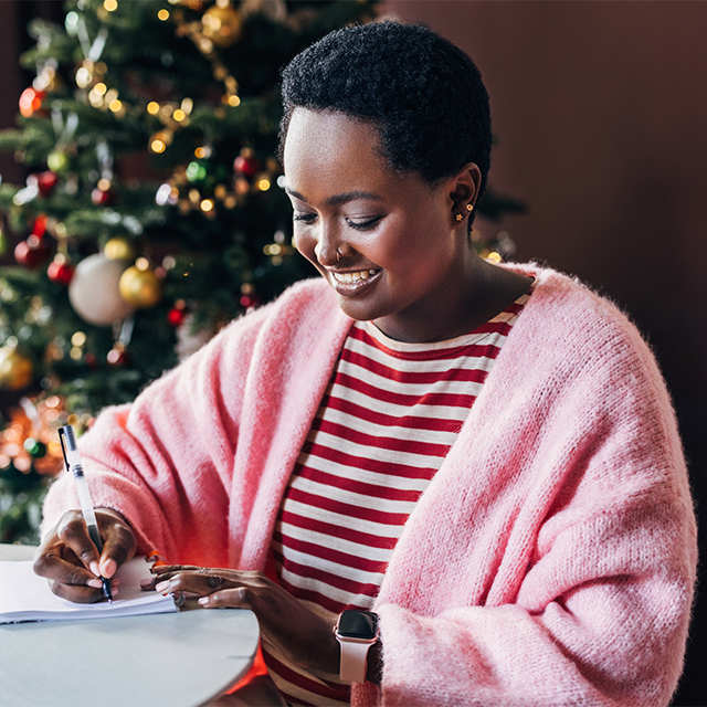 Woman writing new years resolutions