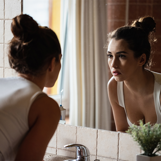 Woman looking in mirror
