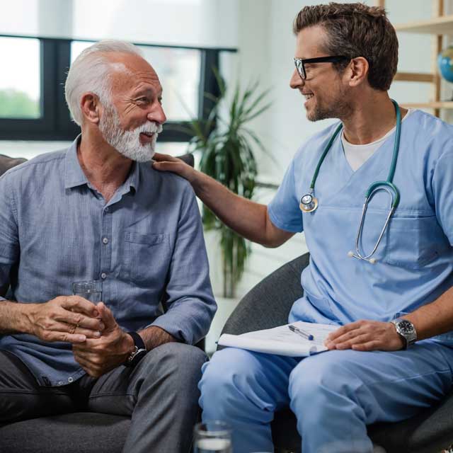 Older man speaking to doctor about enlarged prostate care.