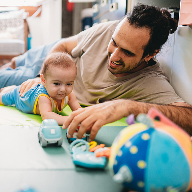 Father and infant, tummy time
