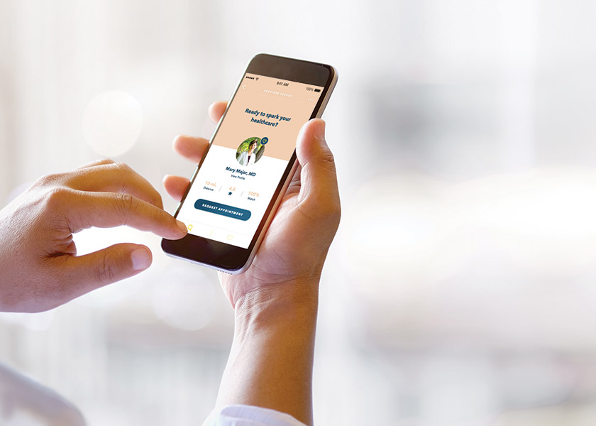 A person holds a smartphone with an app showing to help connect them with a health care provider