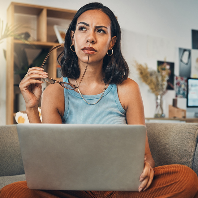 woman thinking at laptop