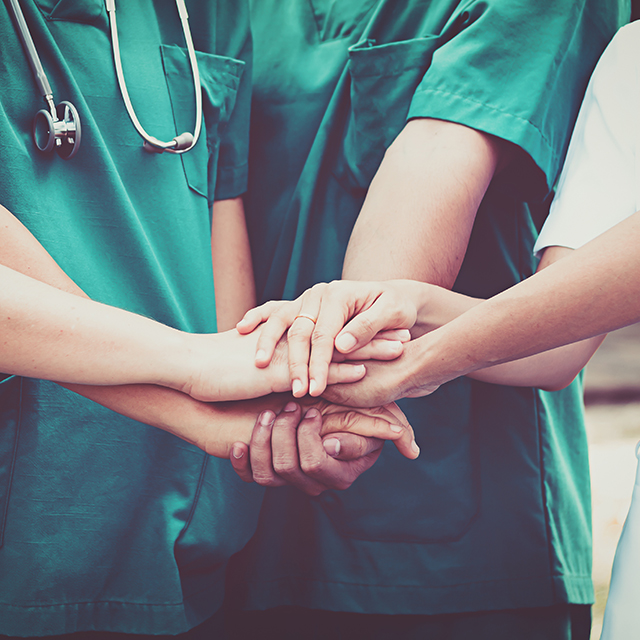 Health care team hands together