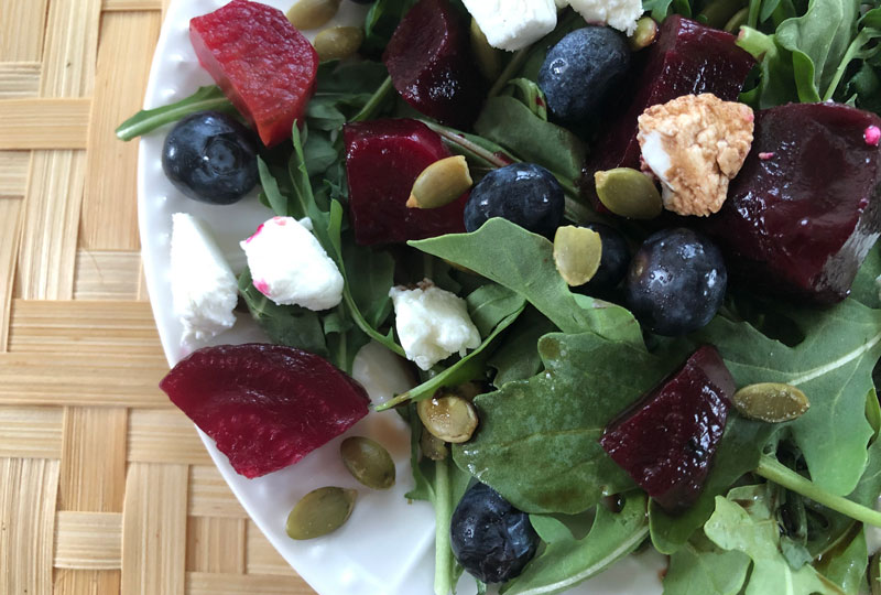 Closeup detail of arugula and beet salad