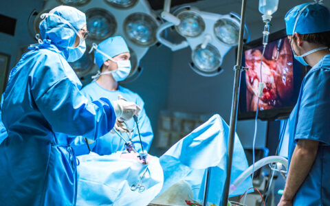 Surgeons in an operating room performing a laparascopic surgery