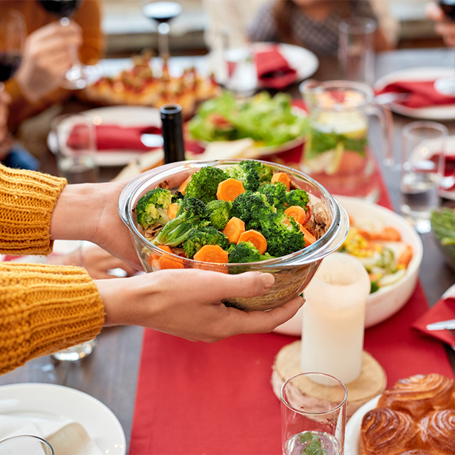Passing vegetable dish at table