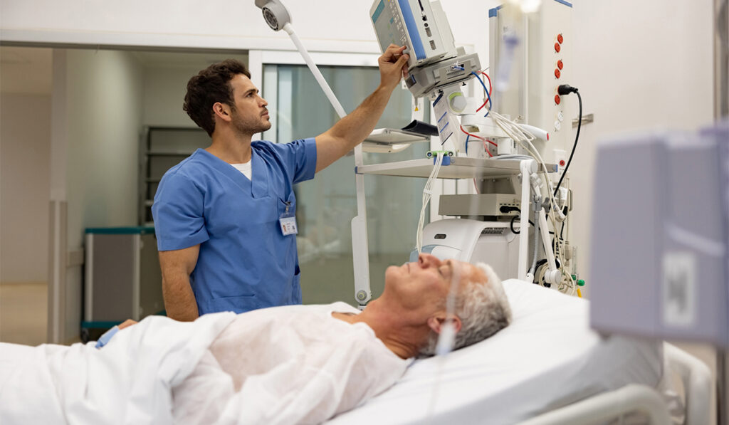 Nurse at the hospital checking the vitals on a hospitalized patient