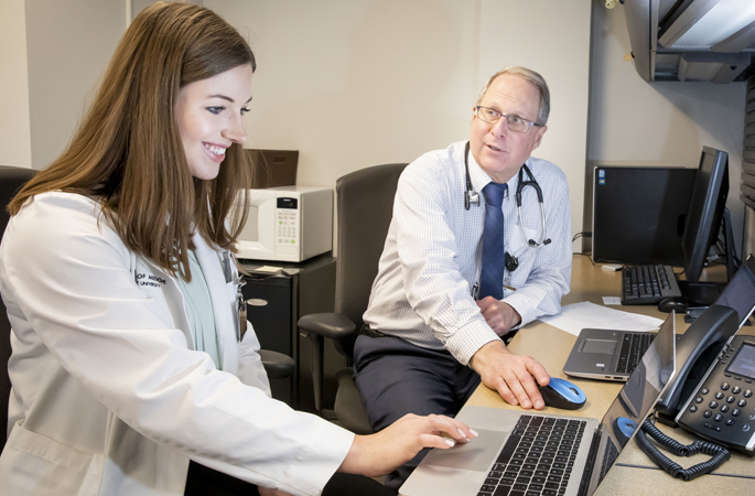Fourth-year VUSM student Emily Long assists Paul Epstein, MD, as he conducts telehealth visits with patients of the Vanderbilt Eskind Diabetes Clinic.