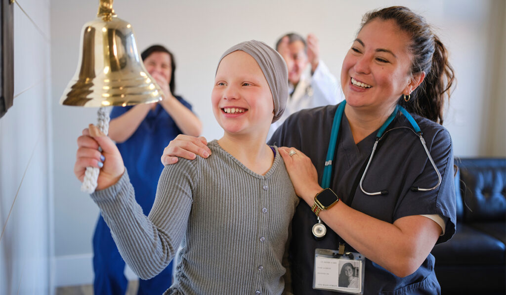 Child Chemotherapy Patient Finishing Treatment with a Ceremonial Bell Ring