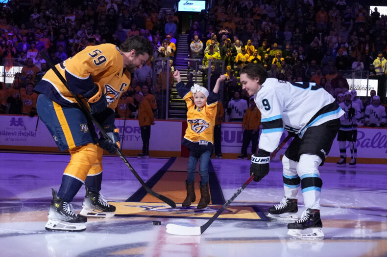 Monroe Carell Jr. Children’s Hospital at Vanderbilt patient Harper Murphy dropped the puck at the Hockey Fights Cancer game Nov. 9, as the Nashville Predators took on the Utah Hockey Club. She’s flanked by Predators captain Roman Josi, left, and Utah’s Clayton Keller. (photo by John Russell)
