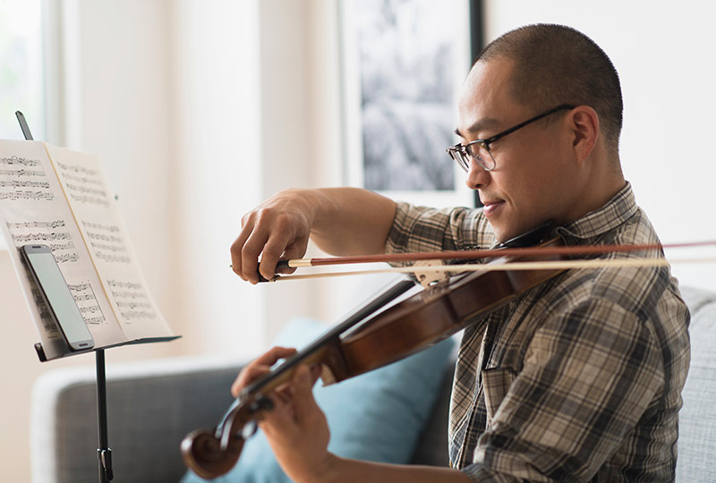 Asian man plays the violin