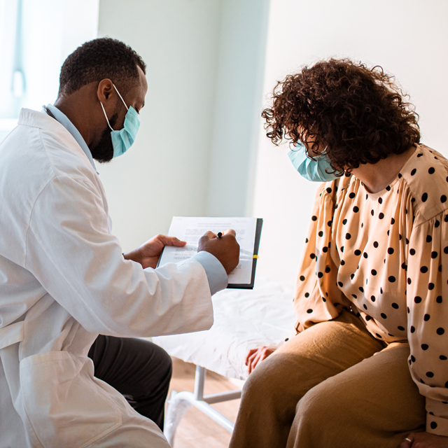 Doctor consulting with patient and answering pancreatic cancer treatment questions