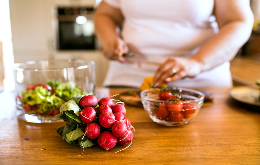 Diabetic patient cooking healthy meal to combat NAFLD.
