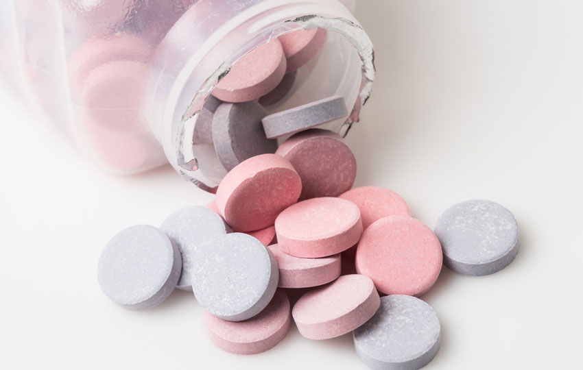 Using Tums for quick heartburn relief.