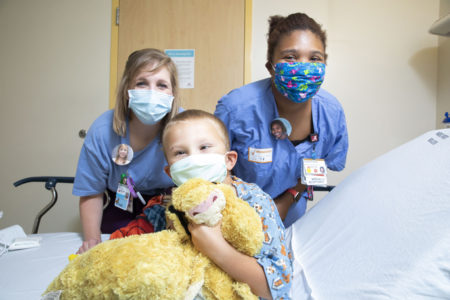 Thanks to the Button Project, Kasen Grief and other patients can see the faces of care providers like Cory Smeltzer, RN, left, and Charlaysia Rucker.