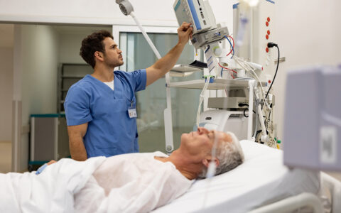 Nurse at the hospital checking the vitals on a hospitalized patient