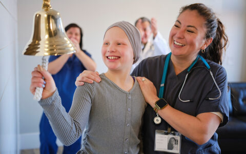 Child Chemotherapy Patient Finishing Treatment with a Ceremonial Bell Ring