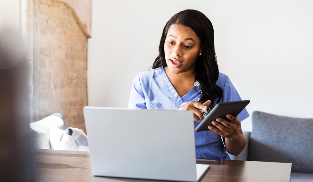 Doctor talking to computer on virtual phone call