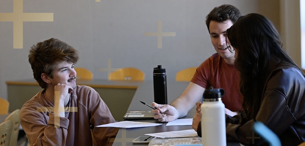 students smiling at table