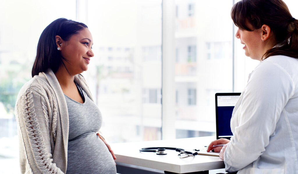 Pregnant woman talking to her doctor