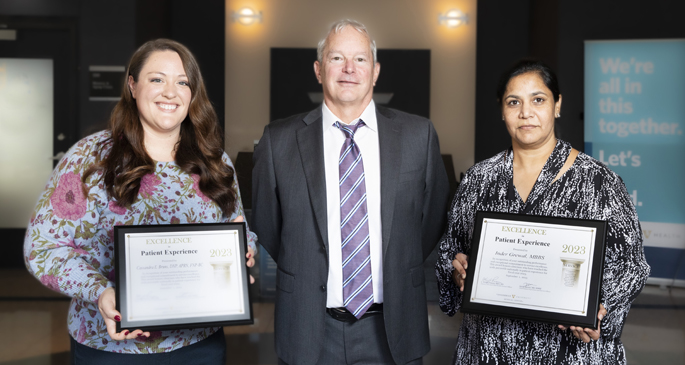Chief Patient Experience Officer David Haynes, MD, center, presented Excellence in Patient Experience awards to Cassandra Bruns, DNP, APRN, FNP-BC, left, and Inder Raj Grewal, MBBS, who had perfect top box scores of 100%. Not pictured is Bethany Sanders, MSN, CNM, who also received a perfect score. (Photo by Susan Urmy)