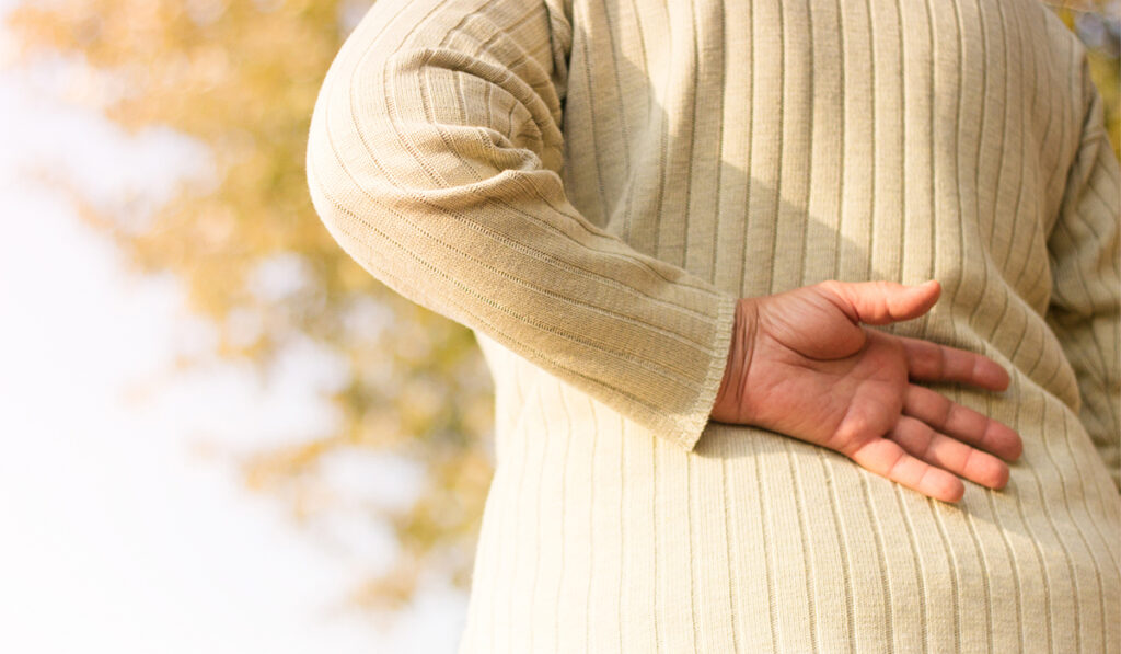 Person with hand on lower back