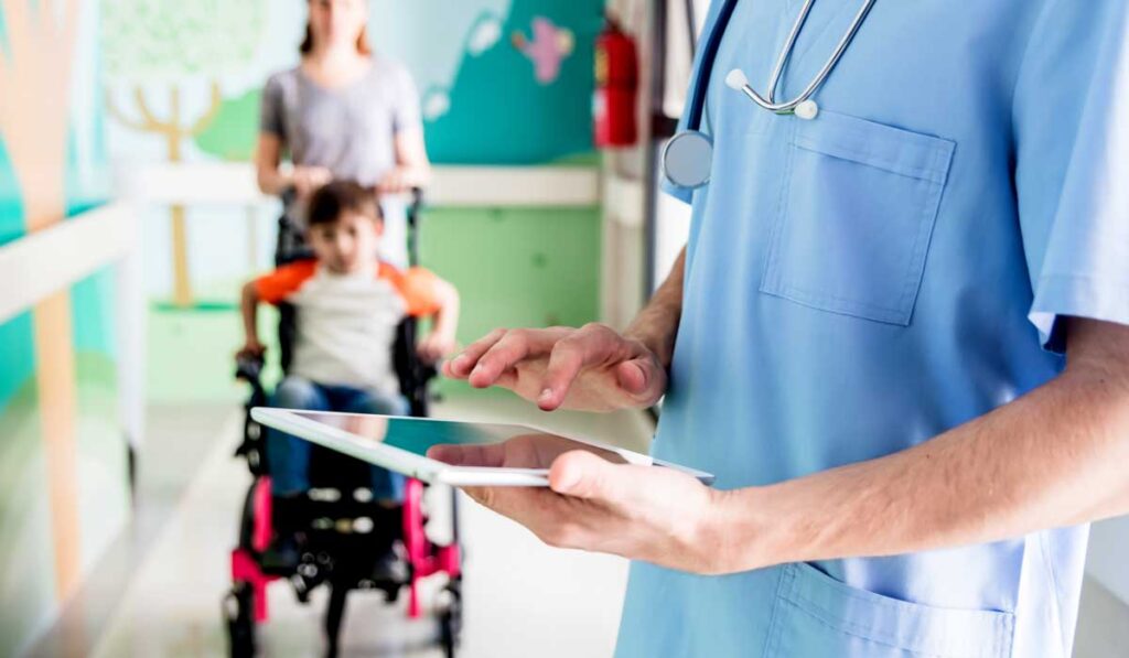 Doctor reviewing chart before talking to child patient
