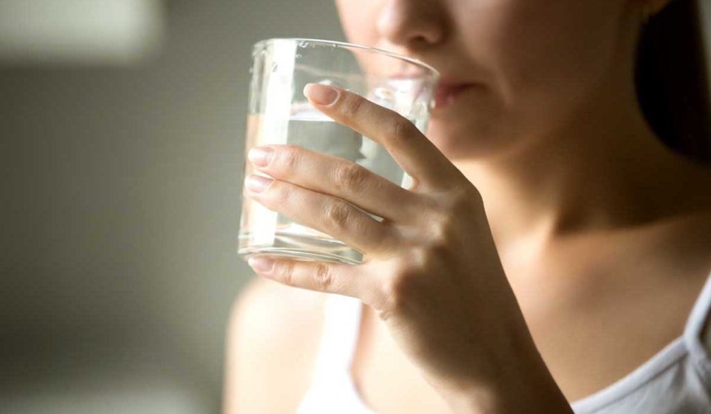 Woman drinking Enterade as a diarrhea remedy.