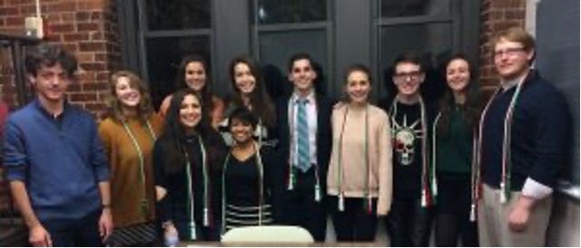 Gamma Kappa Alpha members standing smiling at camera