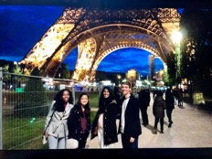 Four VU FRIT students standing underneath the Eiffel Tower