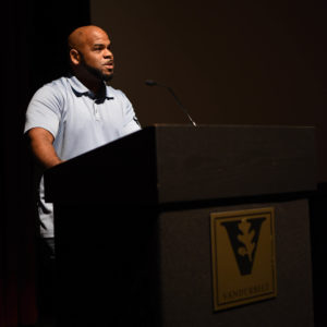 Jonathan Waters standing at a podium