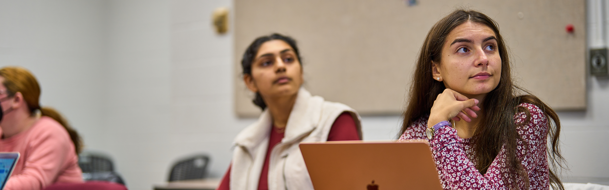 Two students paying attention in class