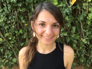 lady posing in front of brick wall